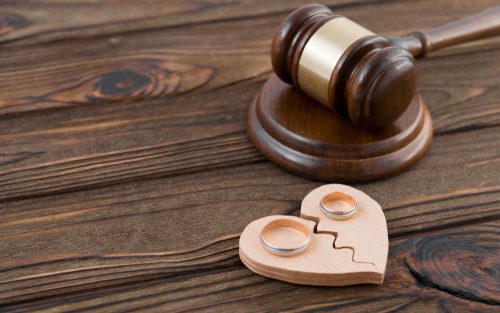 Gavel, broken heart symbol, wedding rings.