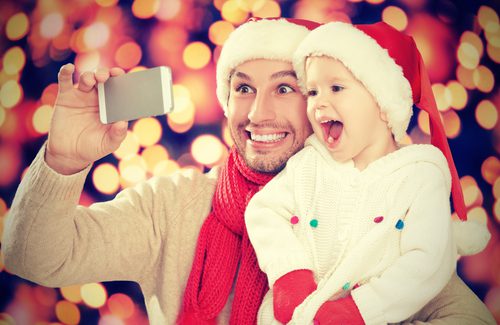 Father and child taking Christmas selfie.