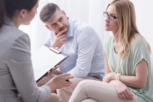 Couple in therapy session with counselor.
