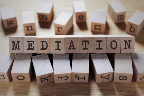 Wooden blocks spelling the word "mediation".