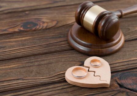Gavel, broken heart symbol, wedding rings.