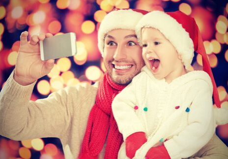 Father and child taking Christmas selfie.
