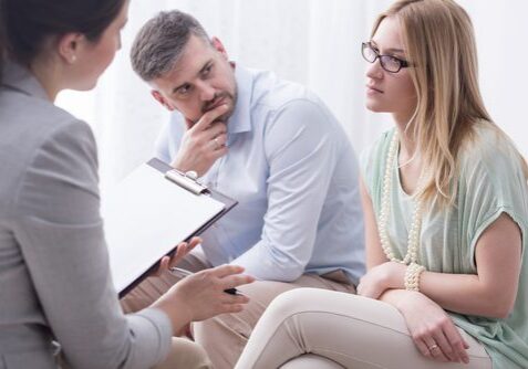 Couple in therapy session with counselor.