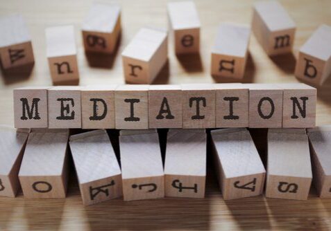 Wooden blocks spelling the word "mediation".